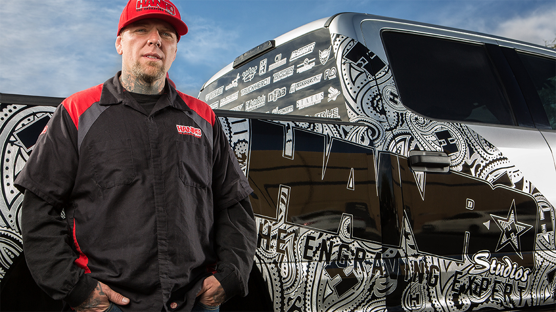 Combat veteran and master engraver Hank Robinson in front of his truck.