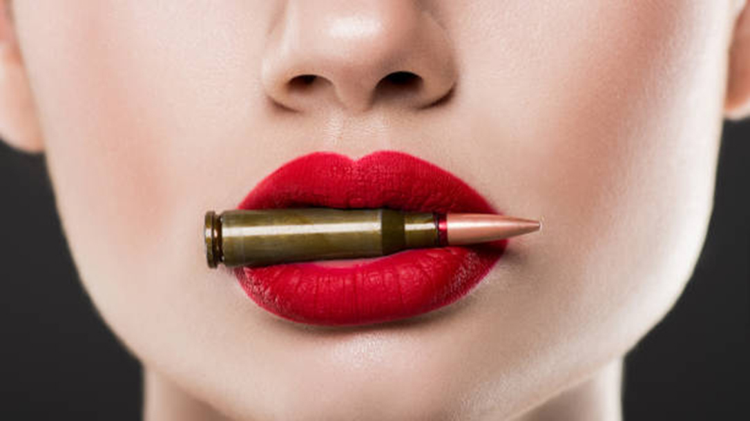 View of a woman with a bullet and red lipstick.
