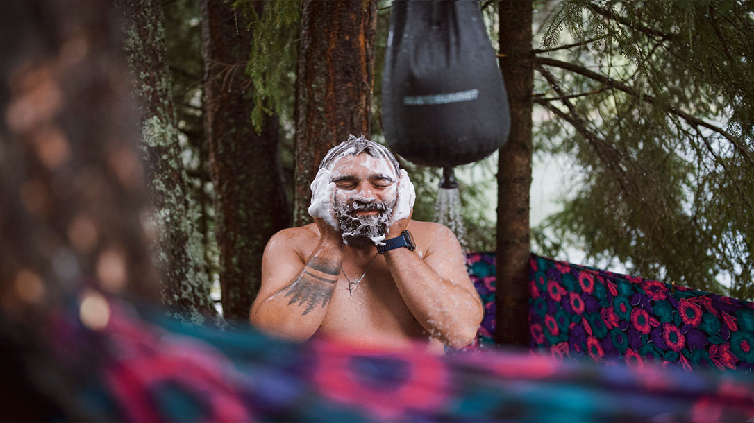 Staying clean in the great outdoors with the help of a camp shower.